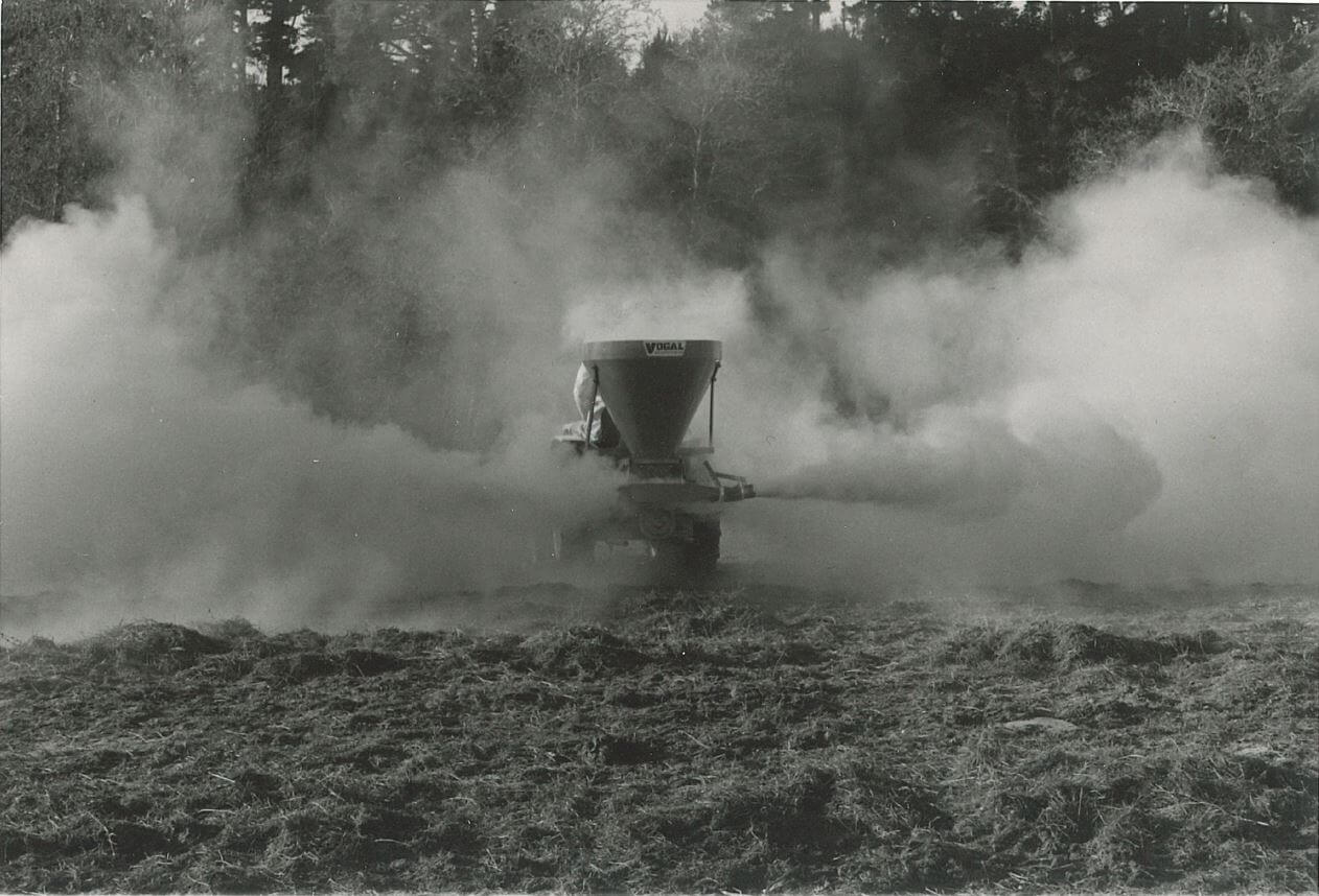 Vogal airblast spreader at work spreading lime or gypsum
