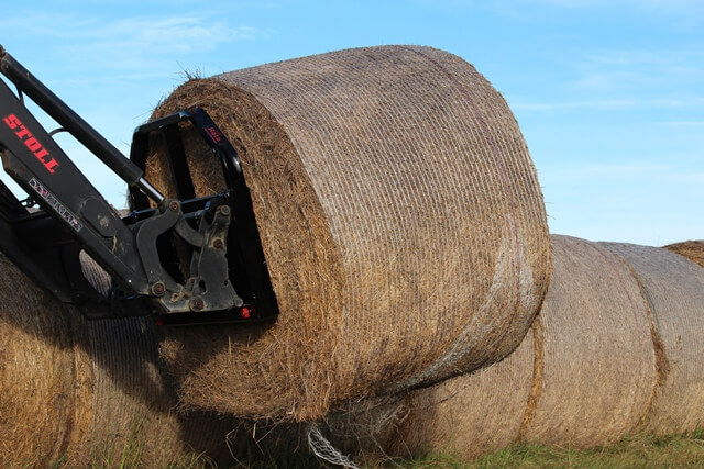 Rata Bale Fork on Stoll tractor loader handling round hay bales