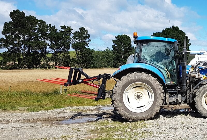 Rata Hay Hauler on the back of a New Holland Farm Tractor
