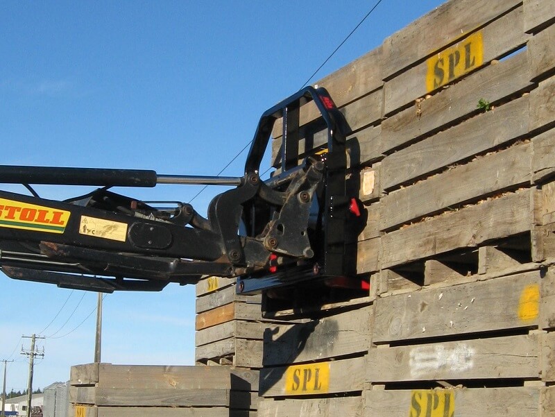 Combo fork on front end loader handling pallet crates