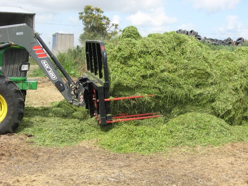 Push Off Buck Rake picking up grass silage