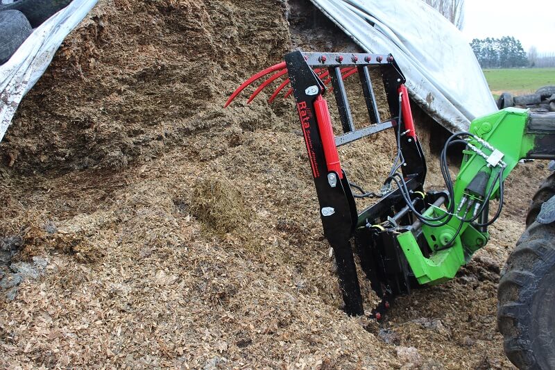 Silage Grab scooping a load of grass silage