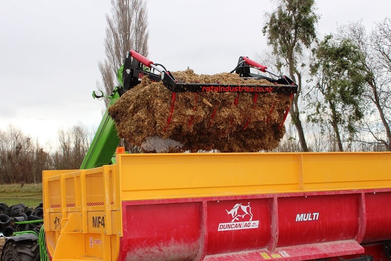 Rata Silage Grab on Merlo Telehandler loading feed out wagon