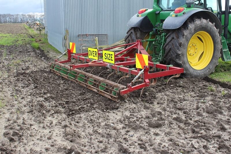 Rata Grubber in a muddy paddock on John Deere Tractor