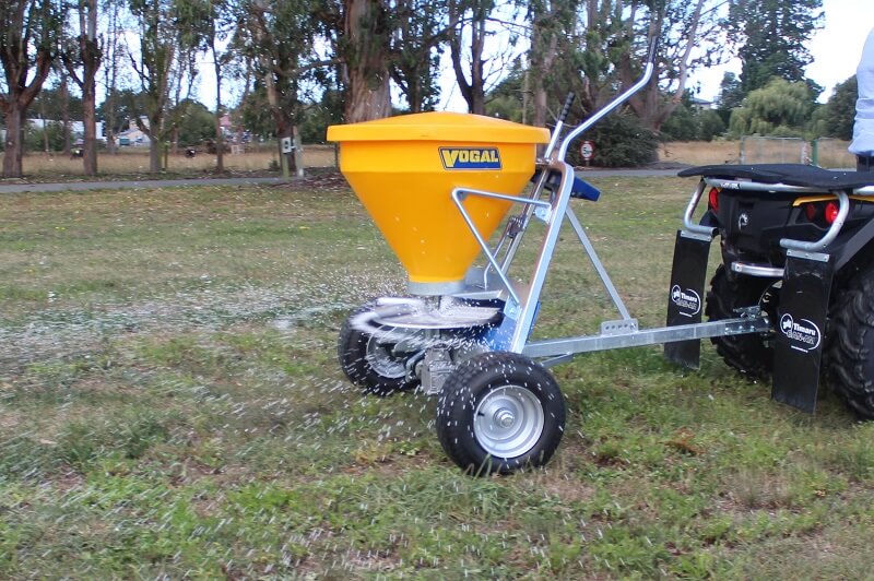 Vogal EX120 spreading fertiliser behind a quad bike