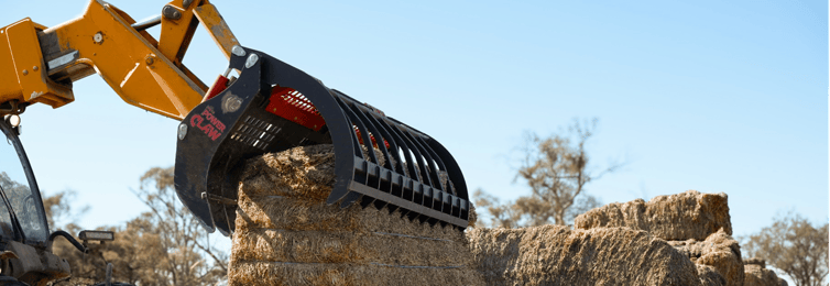 Power Claw grapple attachment picking up hay bales